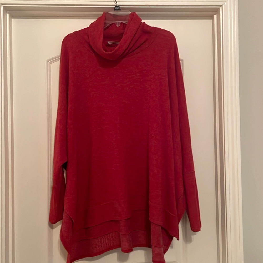 Soft red sweater with cowl neck. Lower in back with slit on sides.